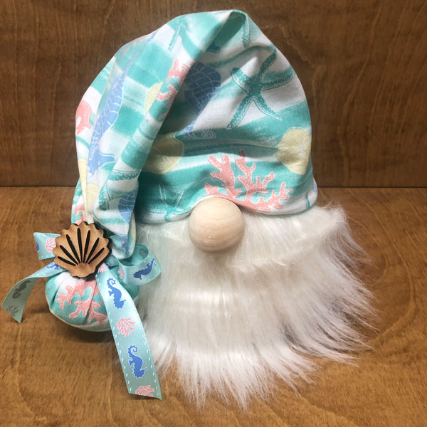 hand crafted gnome with oceanlife theme and engraved shell motif.